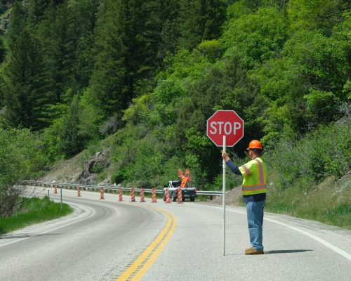 Flagger with a stop sign on an American road
